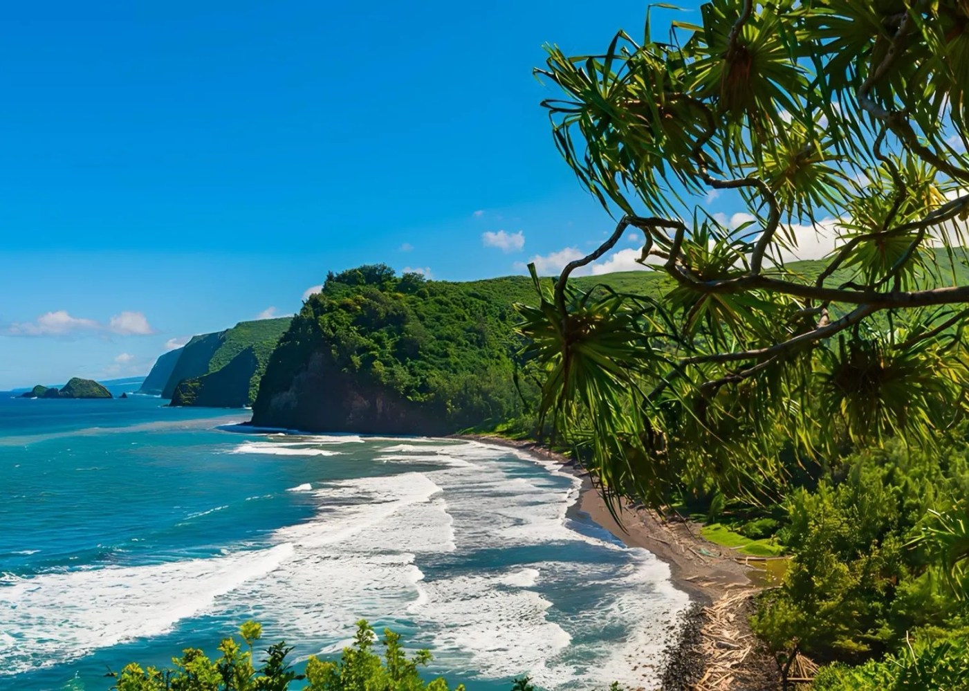 Scenic coastal view with lush green hills and waves crashing on a sandy beach.