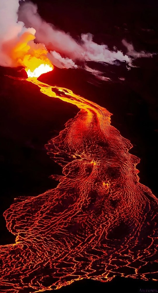 Erupting volcano with glowing lava flow and smoke against a dark background.